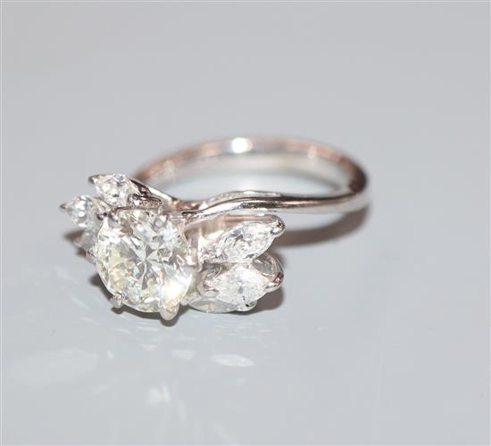 An 18ct white metal and single stone diamond ring, with marquise cut diamond set shoulders, size H/I.